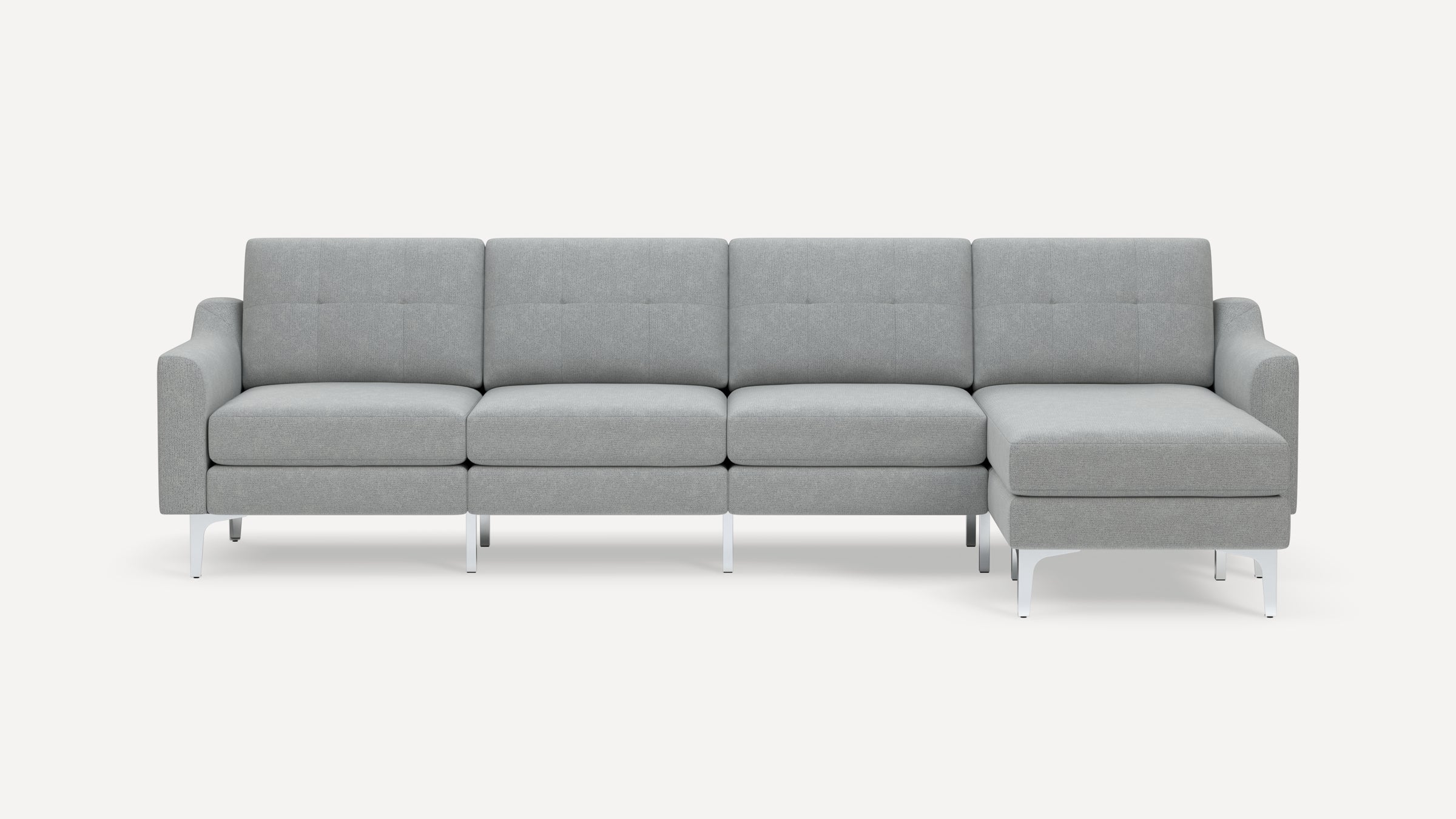 Modern light gray sectional sofa with tufted cushions, clean lines, and metal legs on a white background.