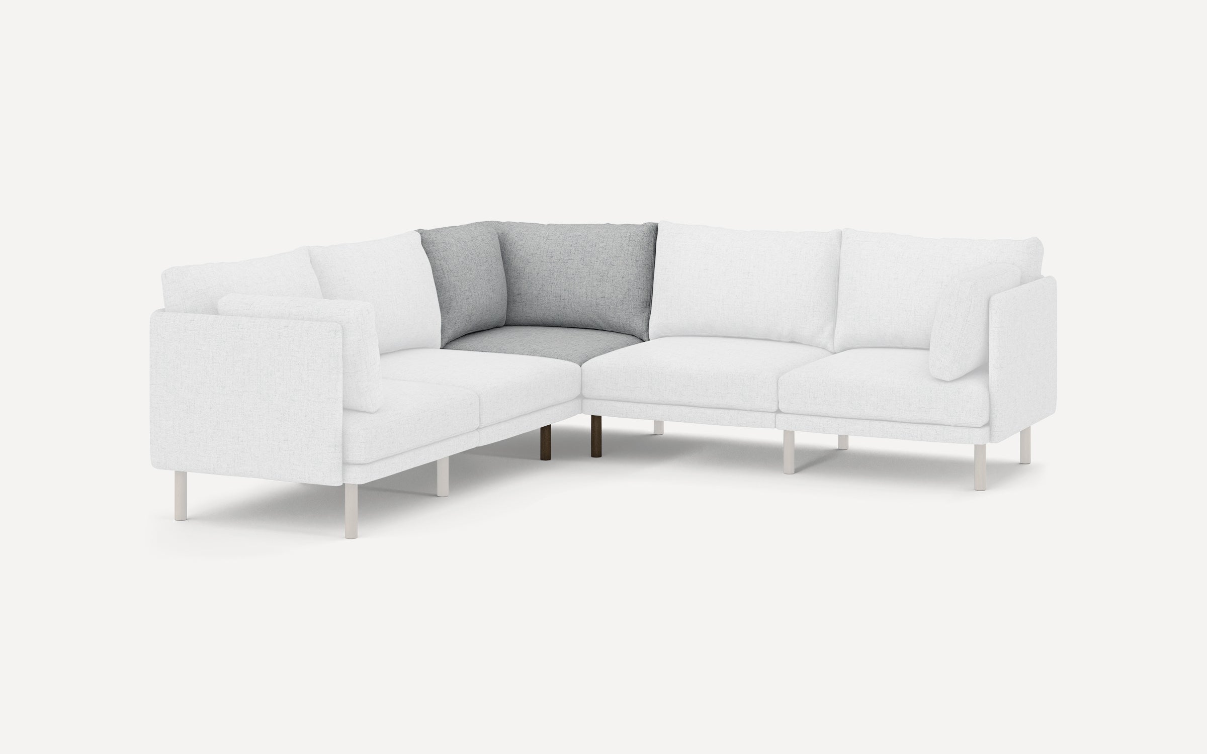 Modern L-shaped sectional sofa with white upholstery and contrasting gray corner cushions, supported by slender light legs.
