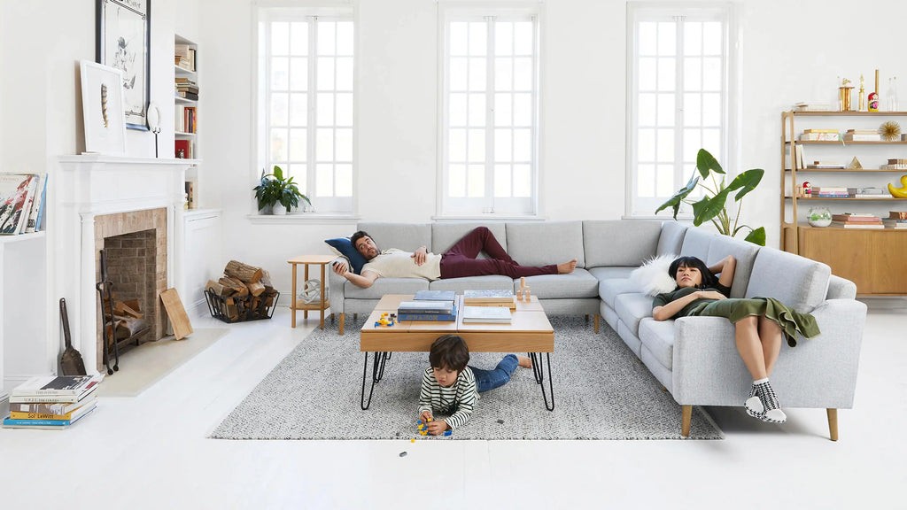 a family sitting on the floor in a living room