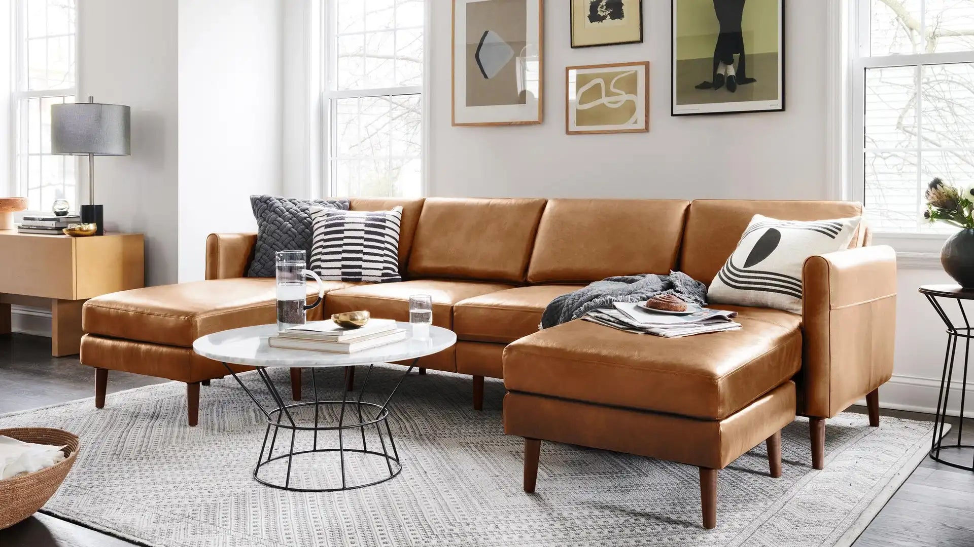 modern leather sectional sofa with chaise lounge and matching ottoman in tan