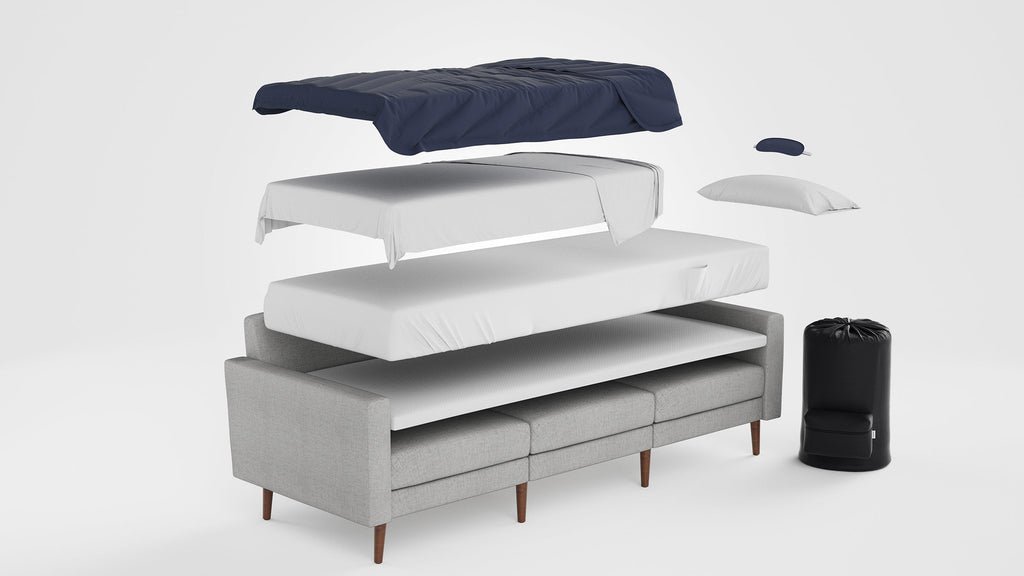 Exploded view of a gray fabric sofa bed with separate cushions, mattress layers, pillow, blanket, and black storage bag.