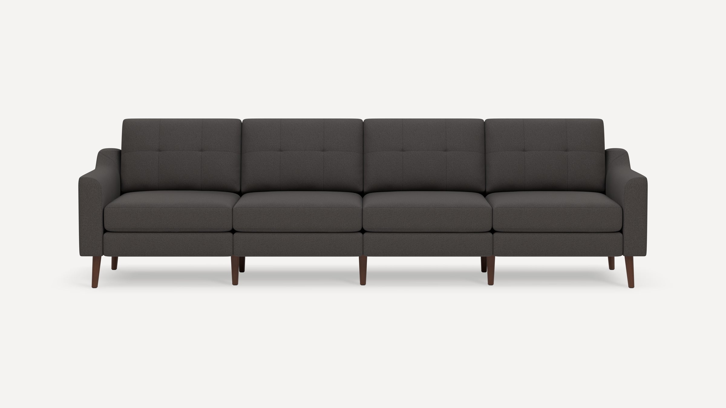 Dark gray four-seater sofa with tufted back cushions, slim arms, and wooden tapered legs, shown against white background.