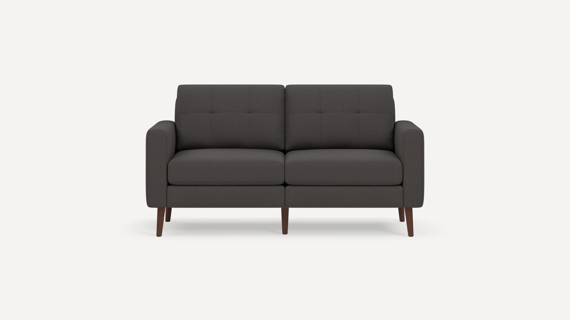 Dark gray modern two-seater sofa with tufted back cushions, rounded armrests, and wooden tapered legs on a white background.
