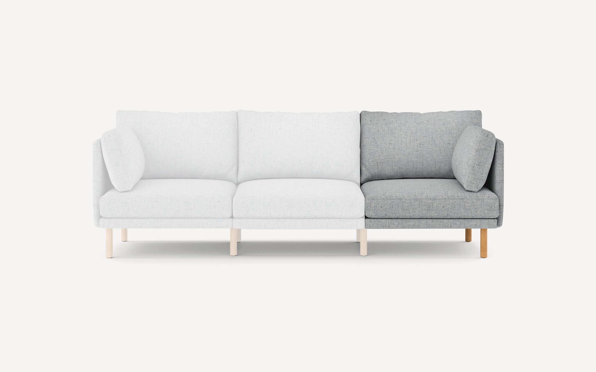 Modern three-seater sofa with light gray fabric upholstery on two seats and darker gray fabric on one seat, featuring wooden legs and cushions.