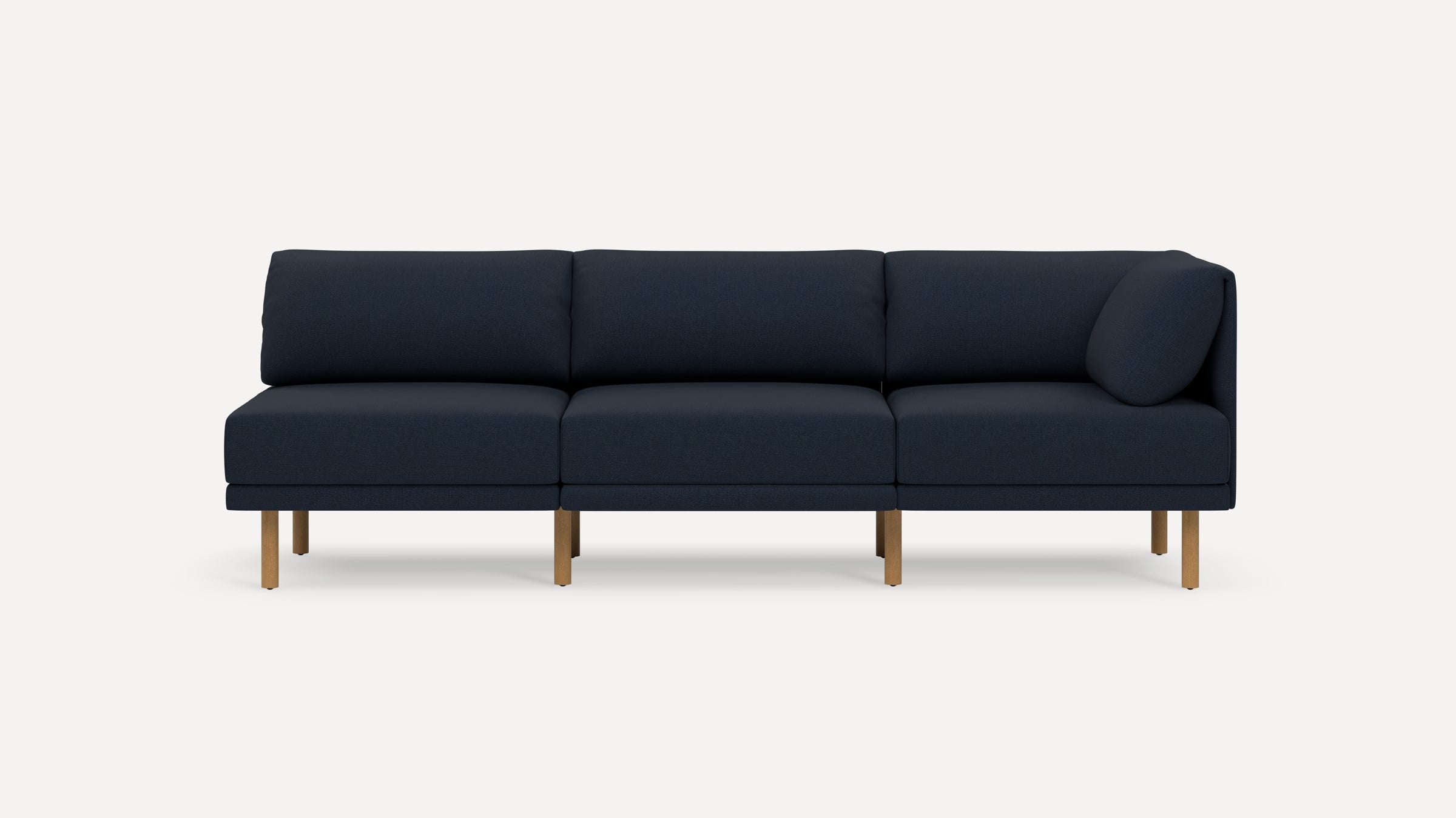 Modern navy blue three-seater sofa with wooden legs, featuring a right-side armrest and cushioned backrest and seat.