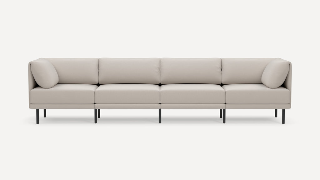 Modern beige four-seater sectional sofa with clean lines, plush cushions, and metal legs on white background.
