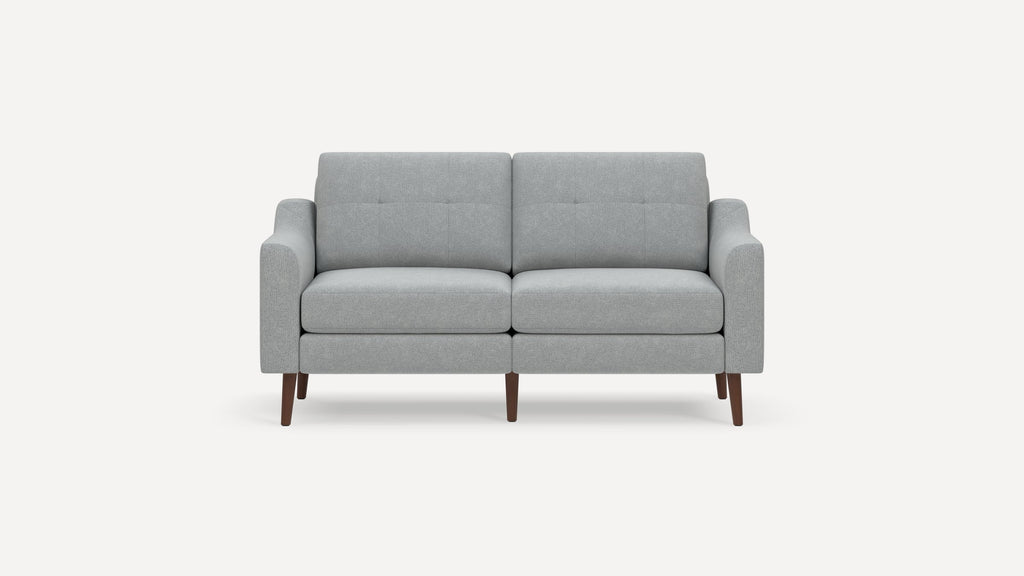 Modern light gray two-seater sofa with clean lines, button-tufted backrest, cushioned seat, and wooden tapered legs.