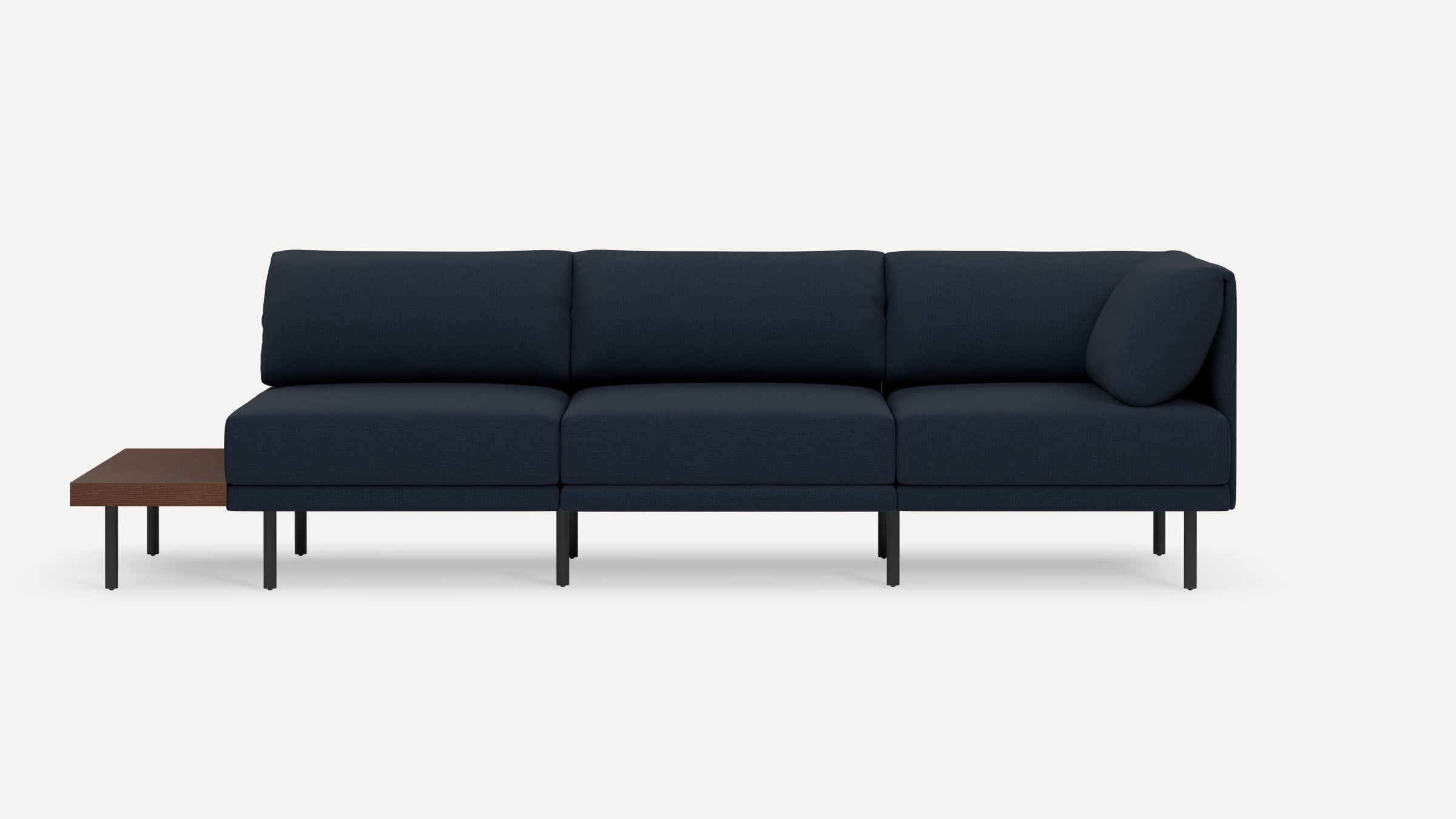 Modern navy blue sectional sofa with three cushion seats, black metal legs, and an attached wooden side table on the left.