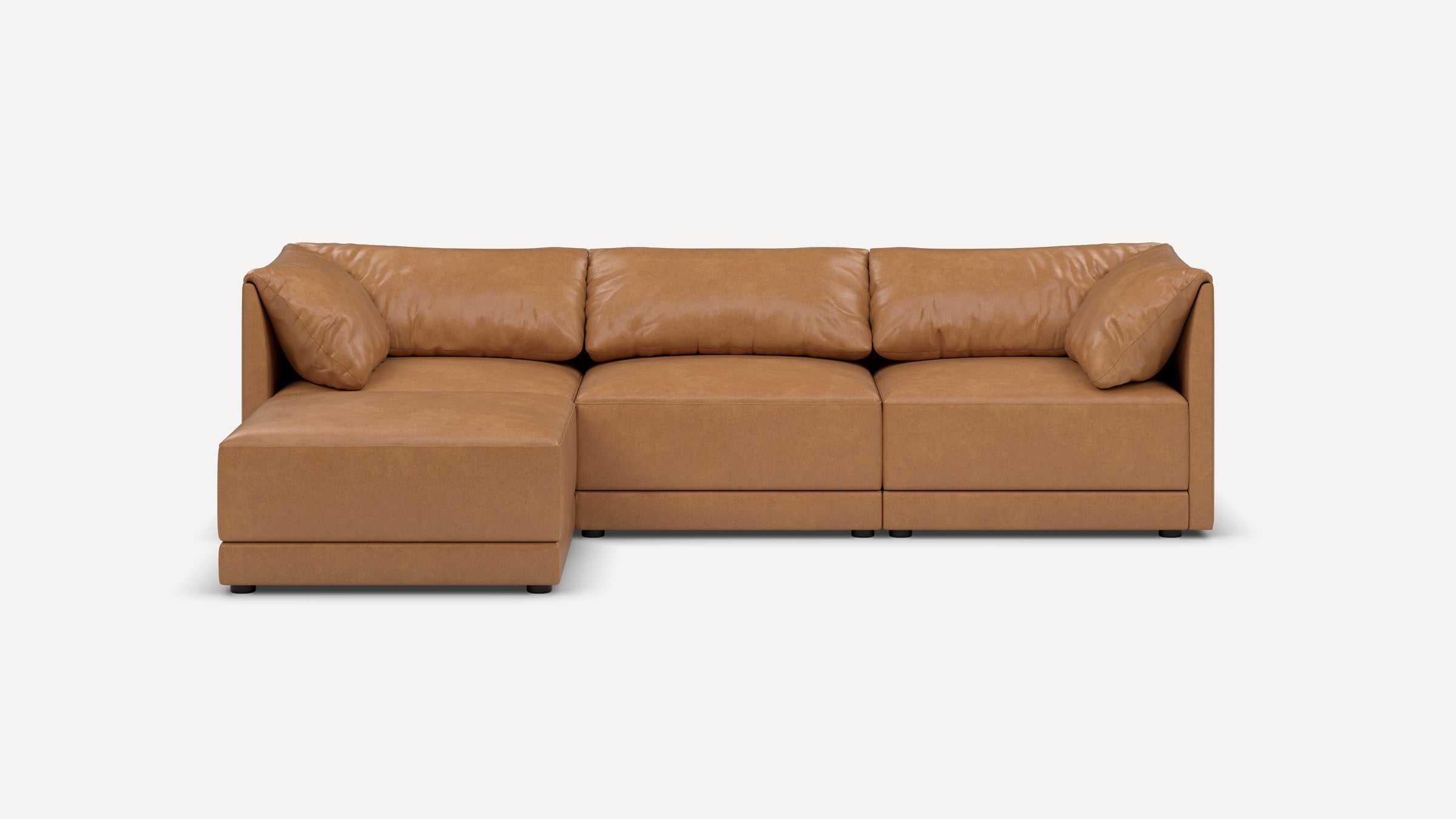 Modern L-shaped sectional sofa in tan leather with plush cushions and a left chaise lounge, designed for comfort and style.