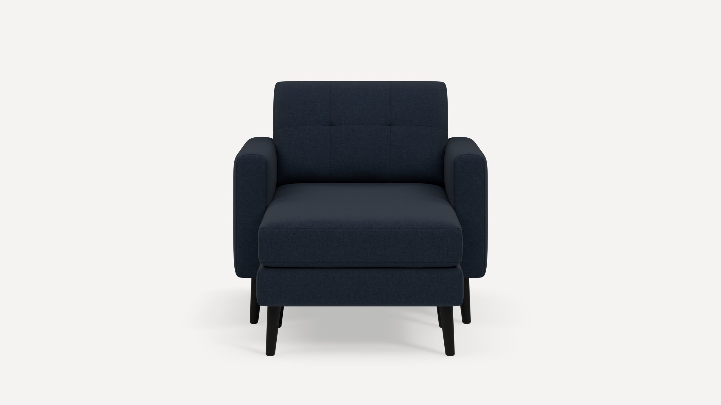 Front view of a modern navy blue upholstered armchair with matching ottoman and black wooden legs on white background.