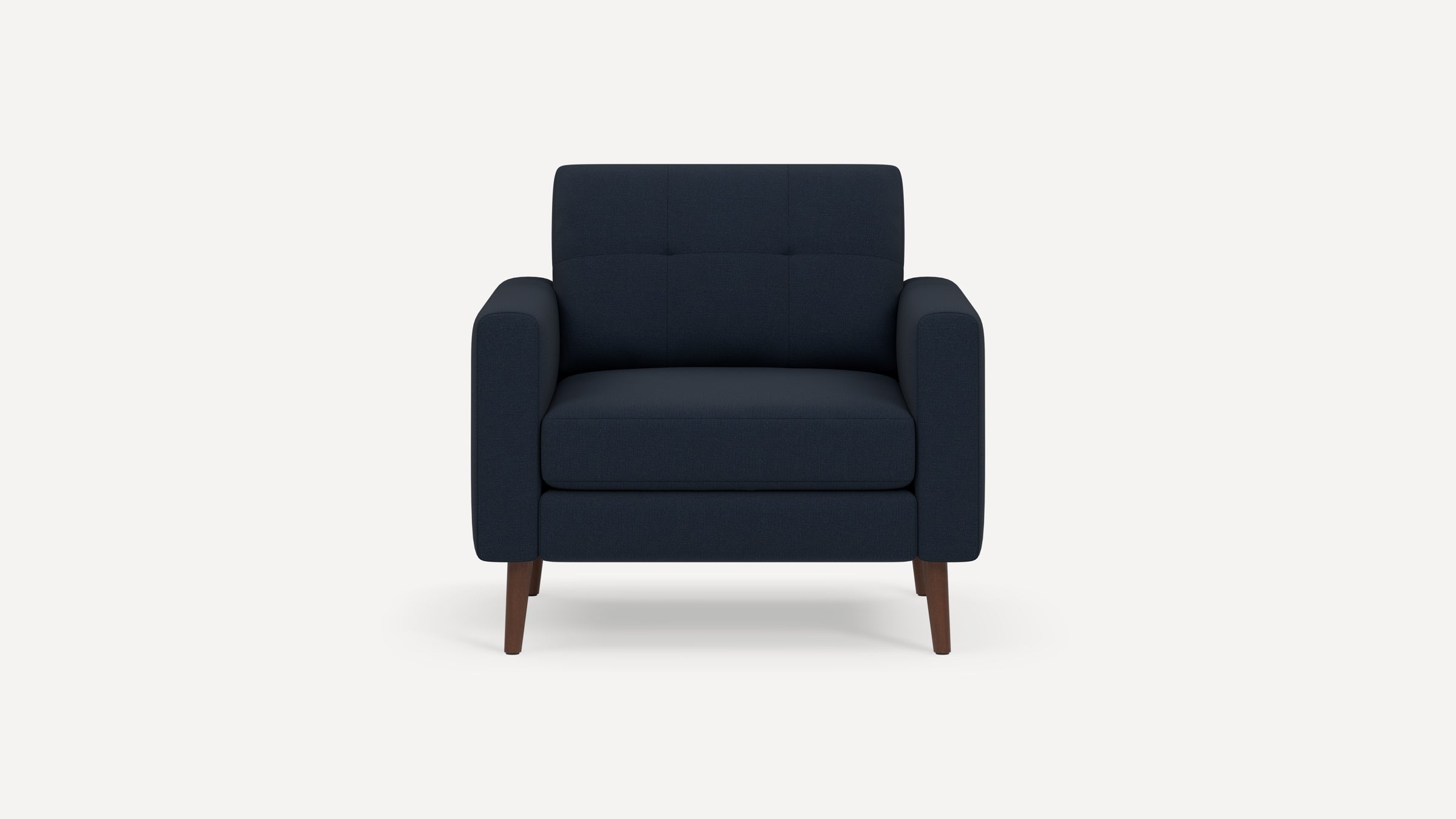Dark navy blue upholstered armchair with tufted backrest and wooden tapered legs, shown against a plain white background.