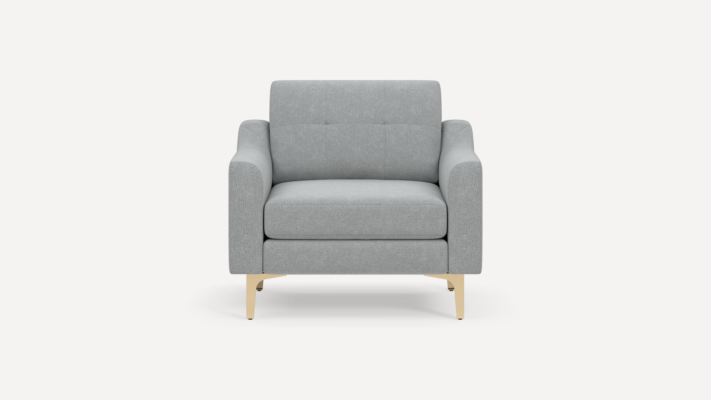Light gray upholstered armchair with sleek, gold metal legs, rectangular arms, and a cushioned backrest with subtle button detailing.