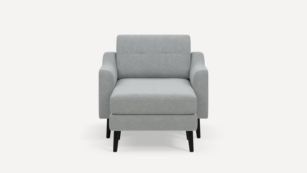 Front view of a modern light gray upholstered armchair with black wooden legs and a cushioned backrest and seat.