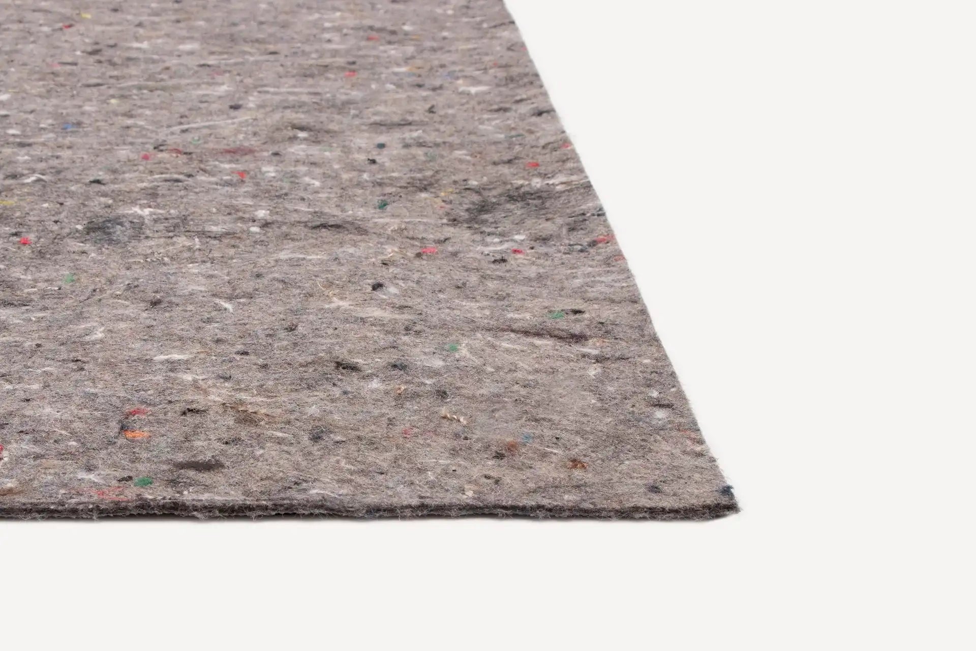 Close-up of a rectangular grey felt carpet underlay with multicolored fiber specks on a white background.
