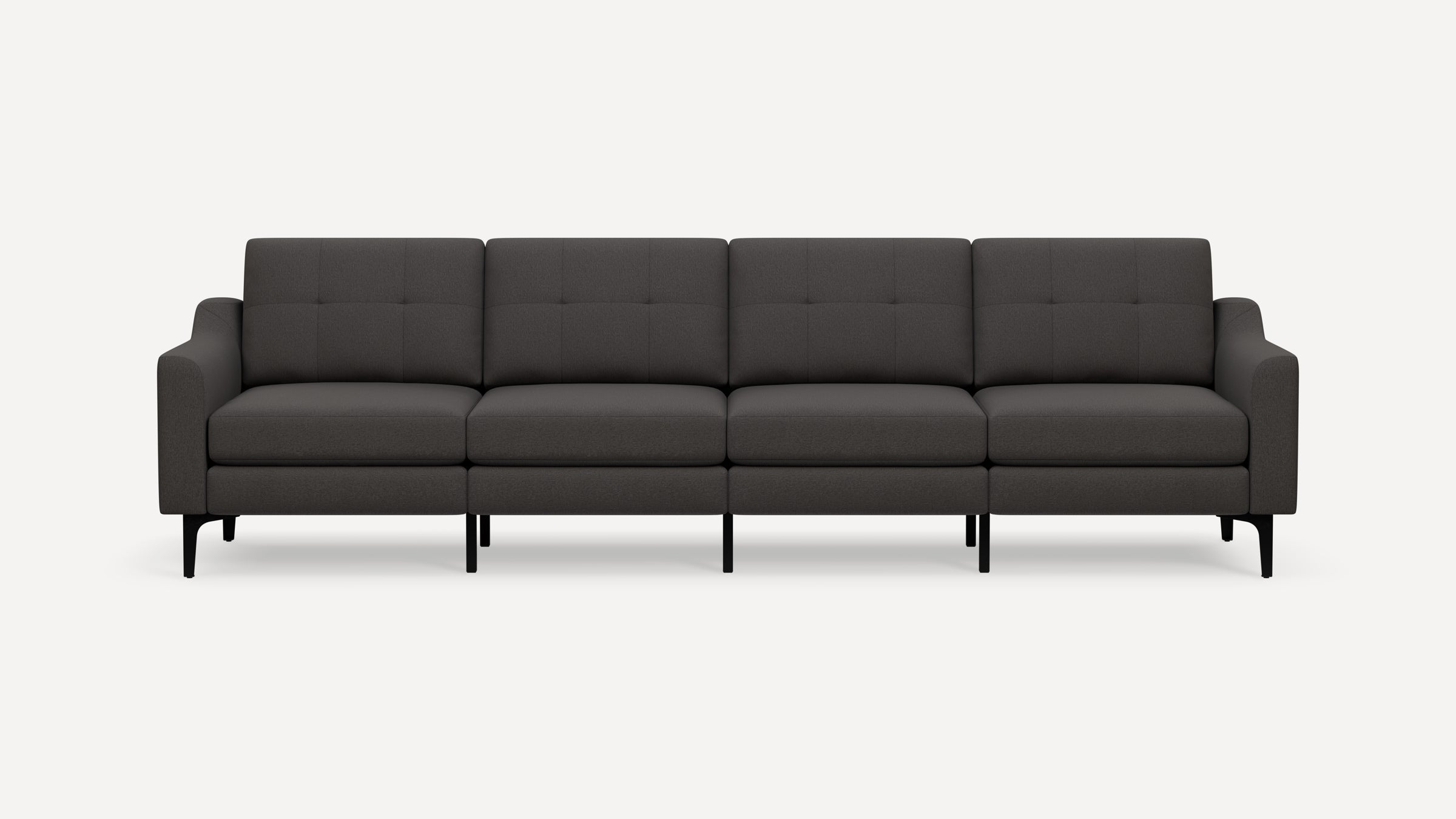 Modern dark gray four-seater sofa with square tufted cushions, upholstered fabric, curved armrests, and black angled legs on white background.