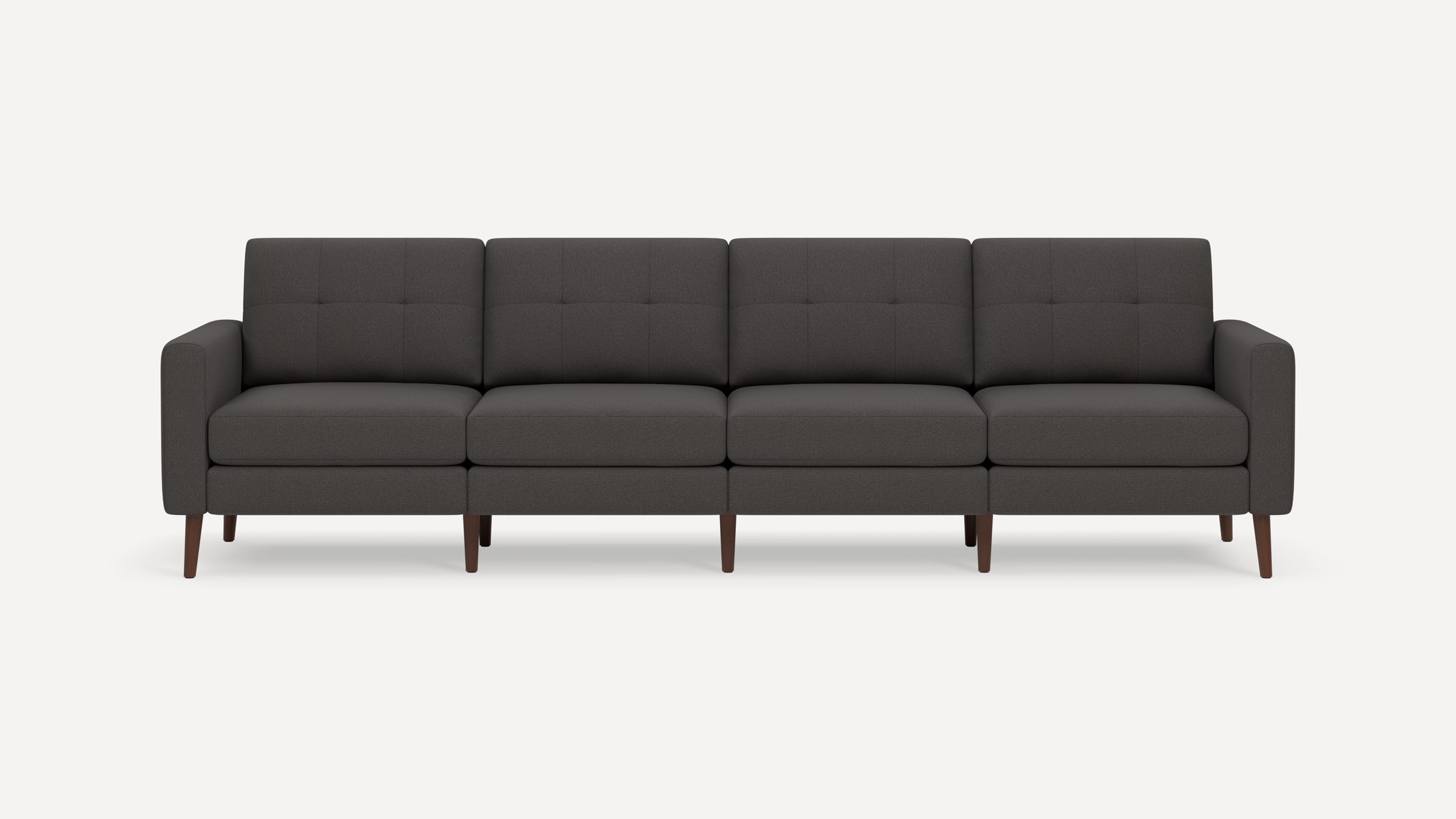 Dark gray four-seat sofa with tufted back cushions, padded arms, and wooden tapered legs on white background.