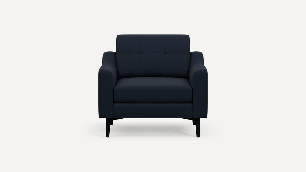 Front view of a modern dark blue upholstered armchair with straight, black legs and slightly curved armrests.