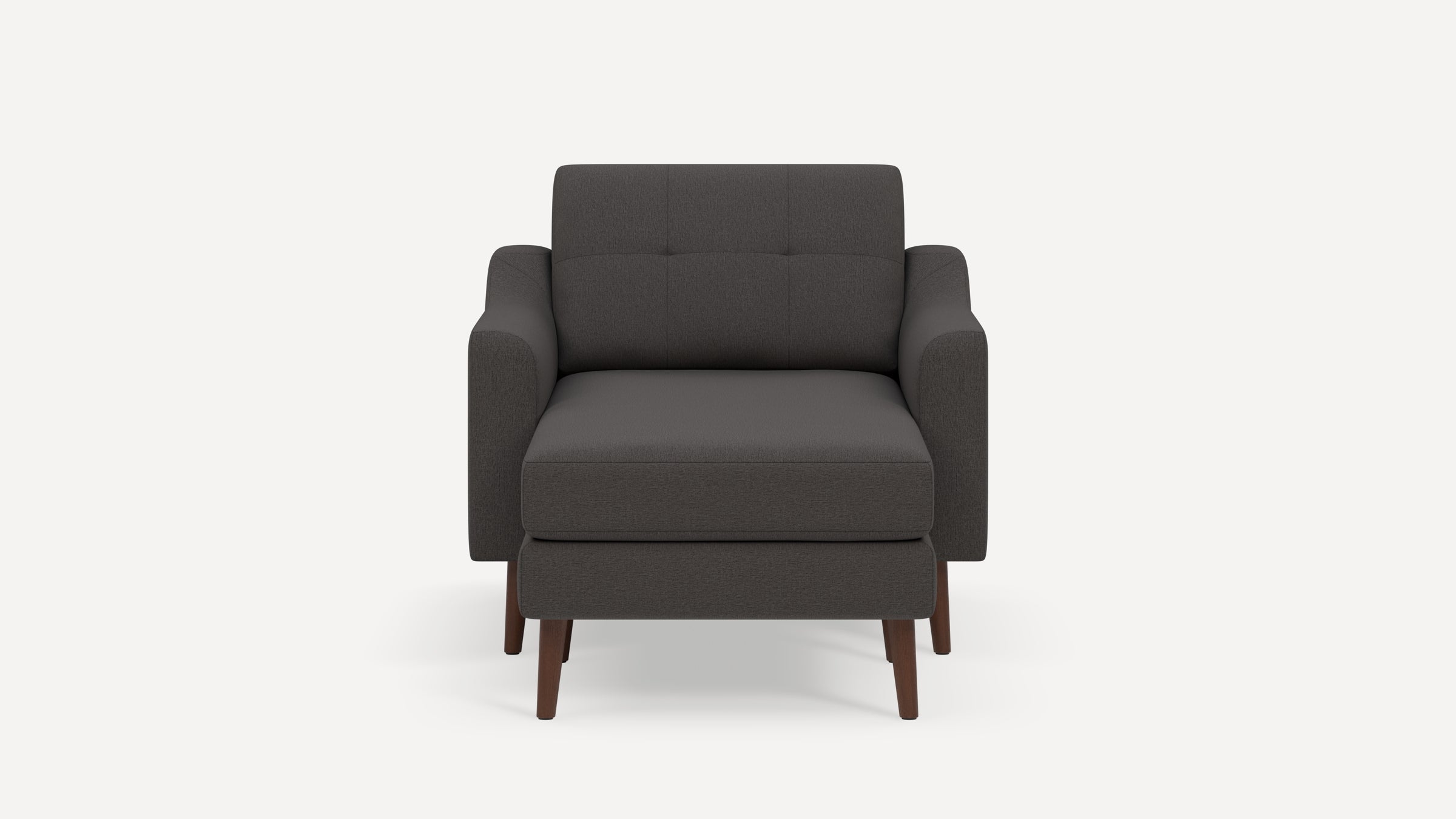 Dark gray upholstered armchair with plush cushions, straight armrests, tufted back, and wooden legs.