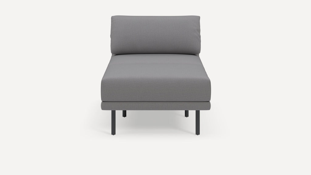 Front view of a modern, gray fabric upholstered armless chair with black metal legs on a white background.