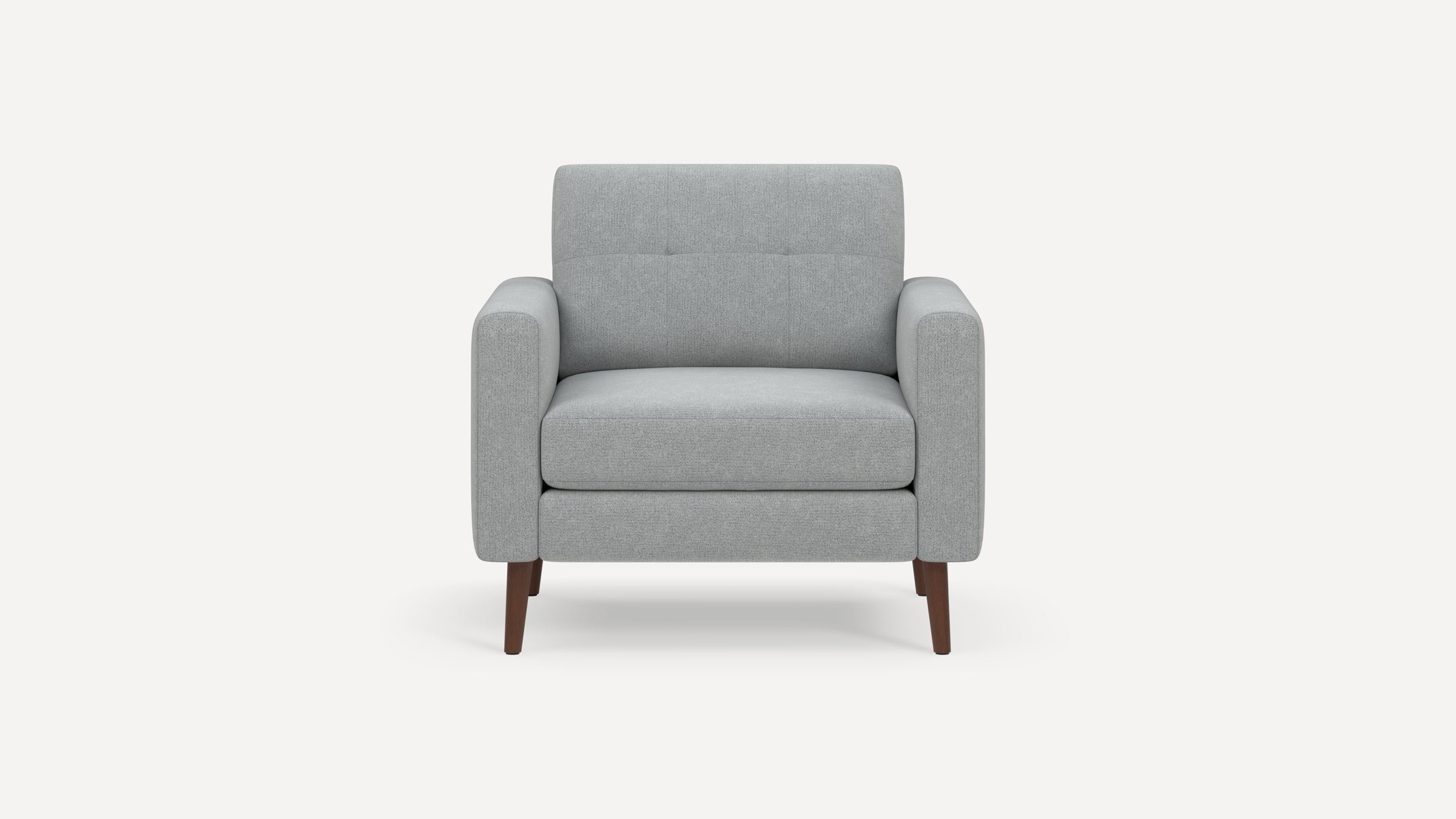 Front view of a modern gray fabric armchair with padded arms, tufted backrest, and wooden tapered legs.