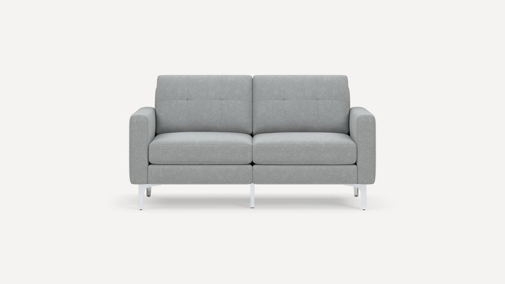 Modern light gray fabric loveseat with clean lines, tufted cushions, and white metal legs on a plain background.