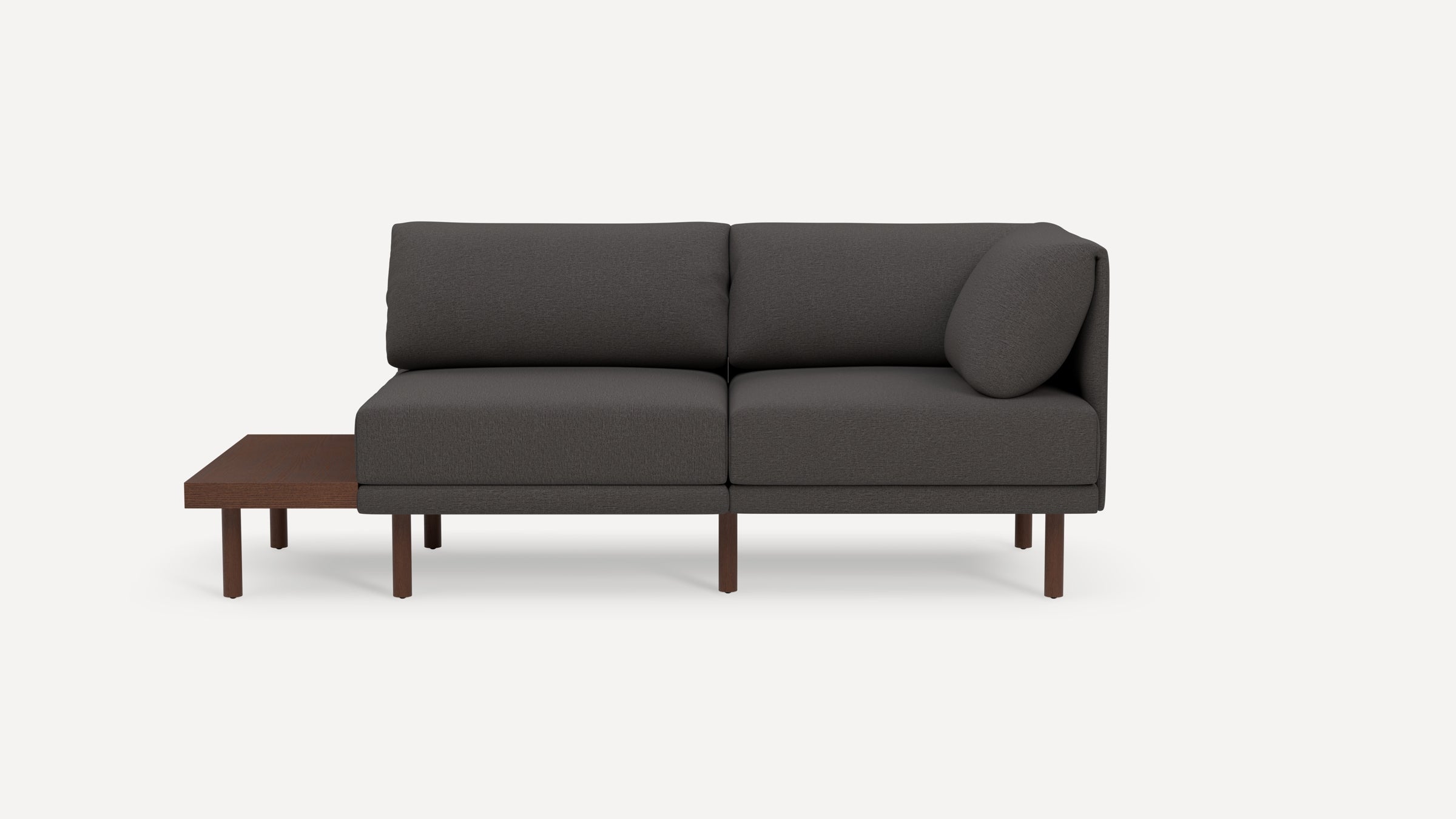 Modern dark gray fabric sectional sofa with wooden legs and an attached wooden side table on the left side.