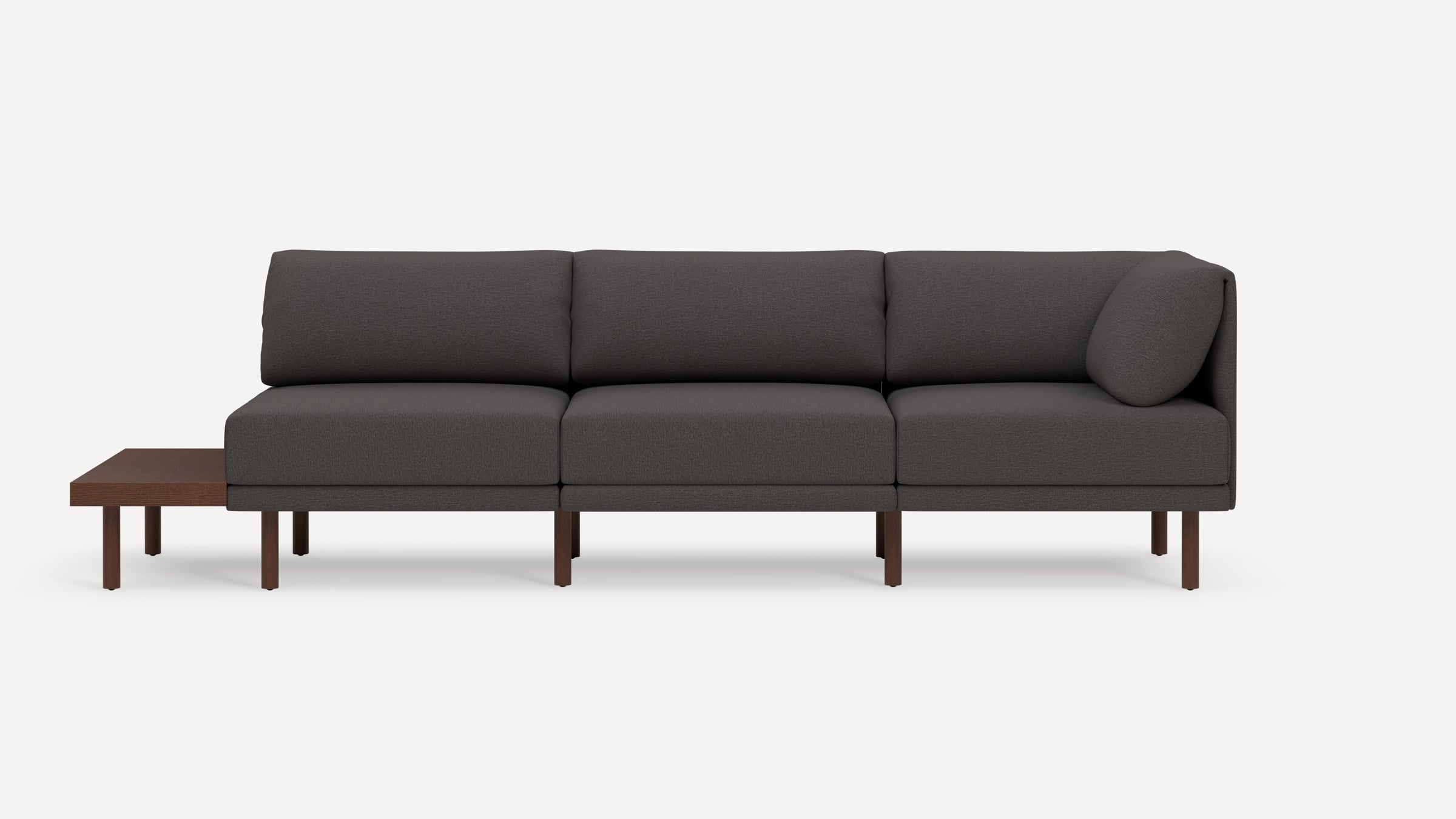 Modern dark gray sectional sofa with wooden legs and an attached side table on the left end, minimalist design.