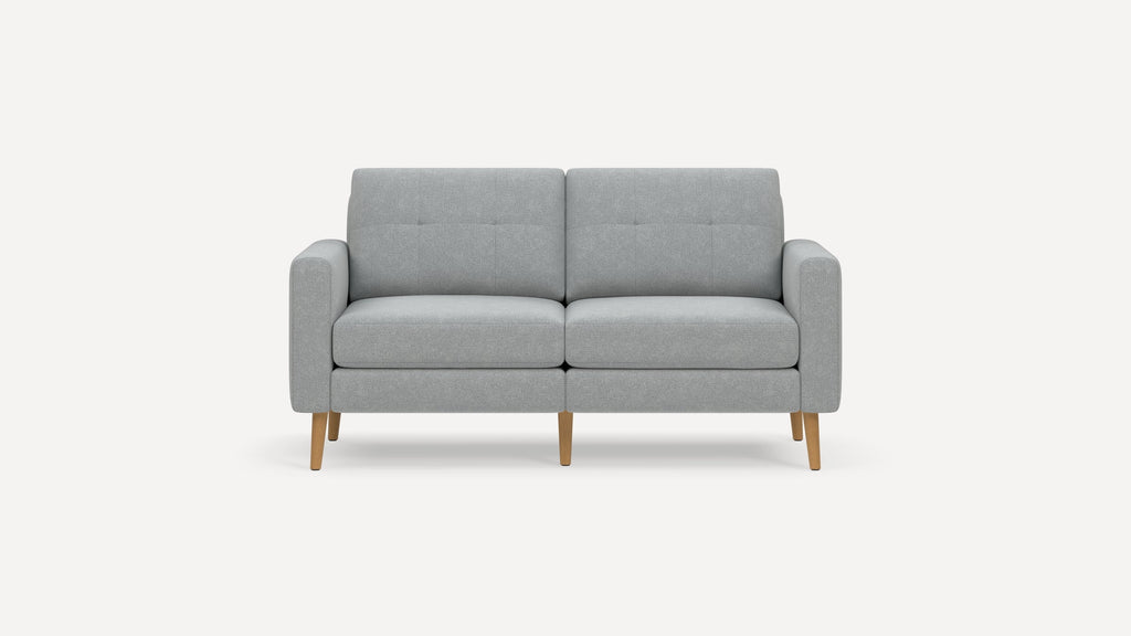 Modern light gray fabric loveseat with wooden tapered legs and button-tufted back cushions on a white background.
