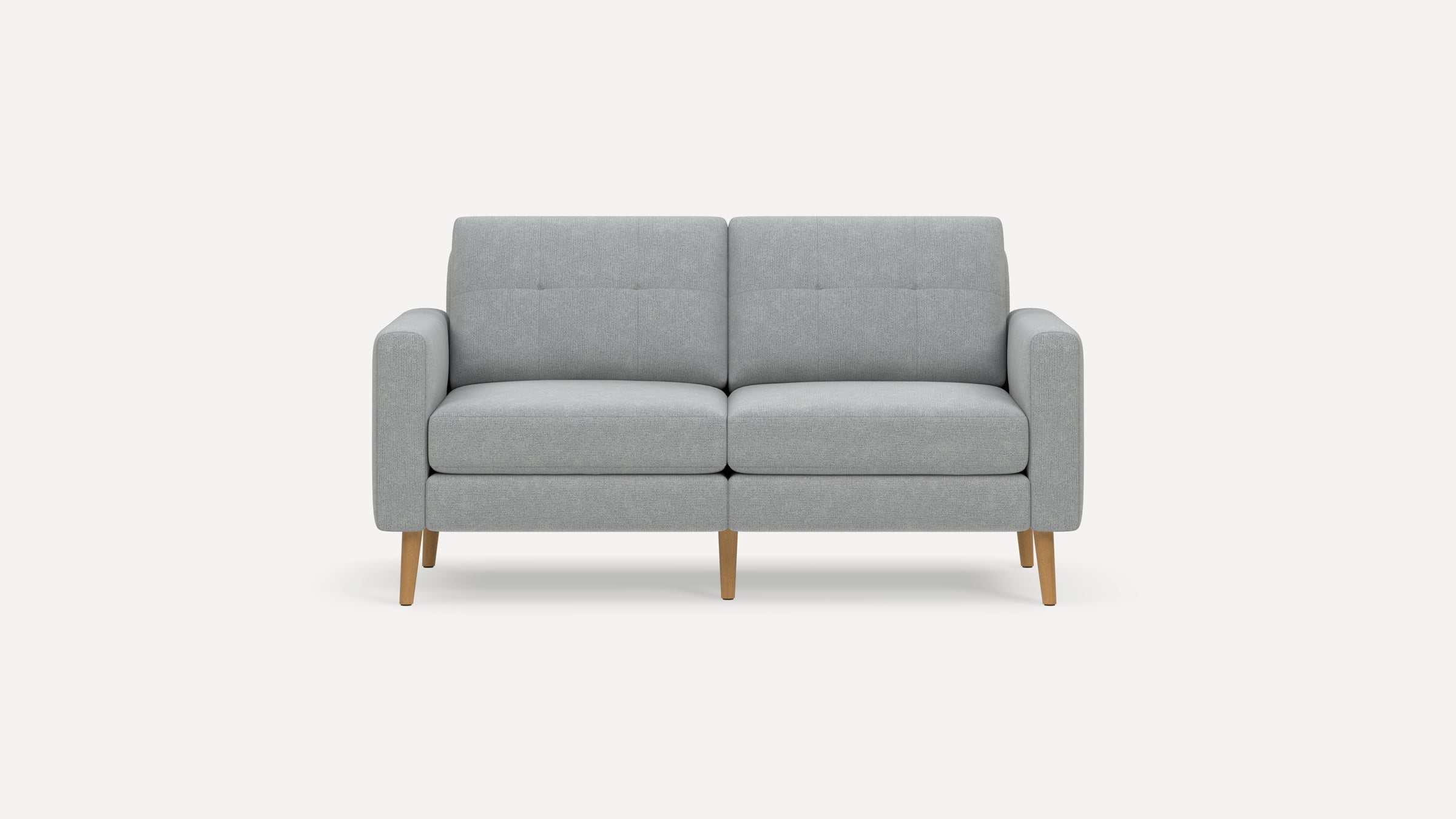 Modern light gray fabric loveseat with wooden tapered legs and button-tufted back cushions on a white background.