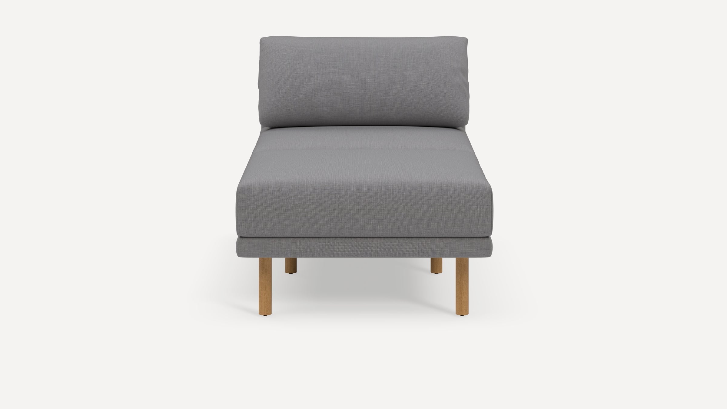 Modern armless grey upholstered chaise lounge with wooden legs, featuring a cushioned backrest and seat.