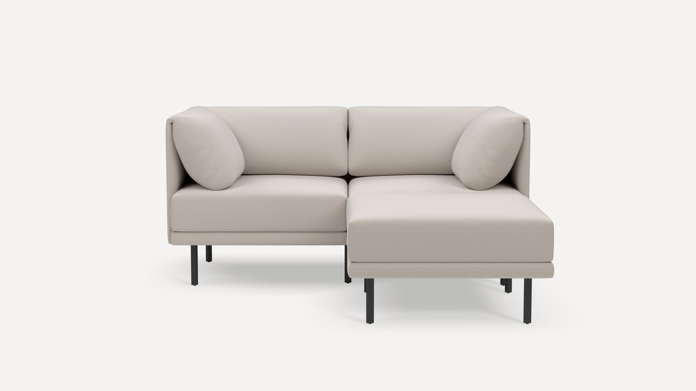 Modern light beige fabric sectional sofa with black metal legs, two corner cushions, and a right chaise lounge on a white background.