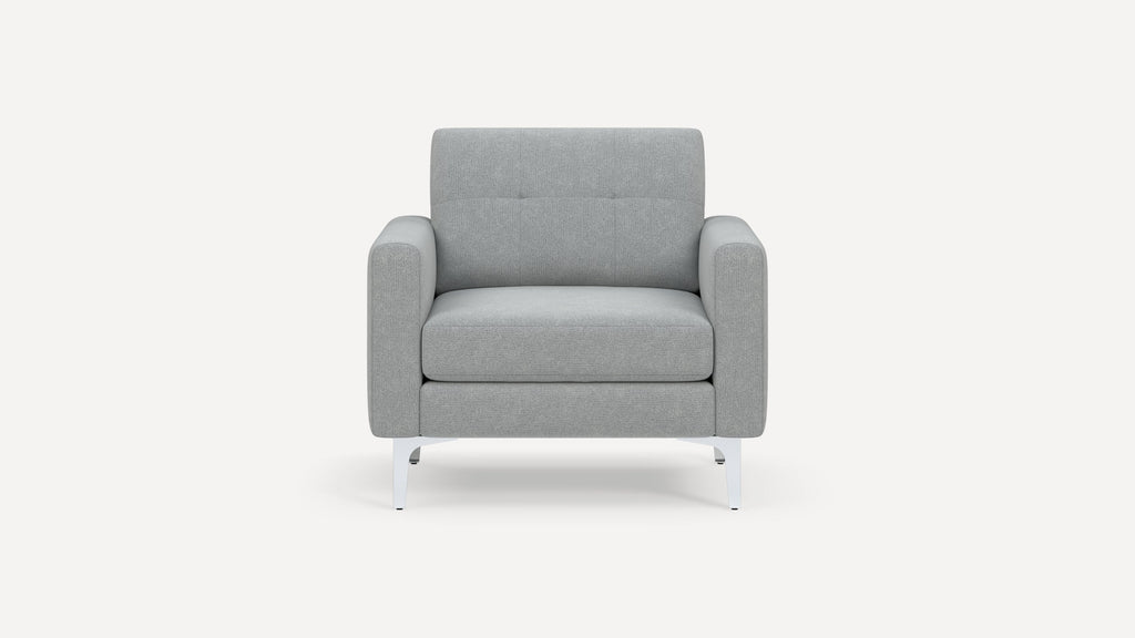 Modern light gray upholstered armchair with square arms, tufted backrest, and white metal legs, front view.