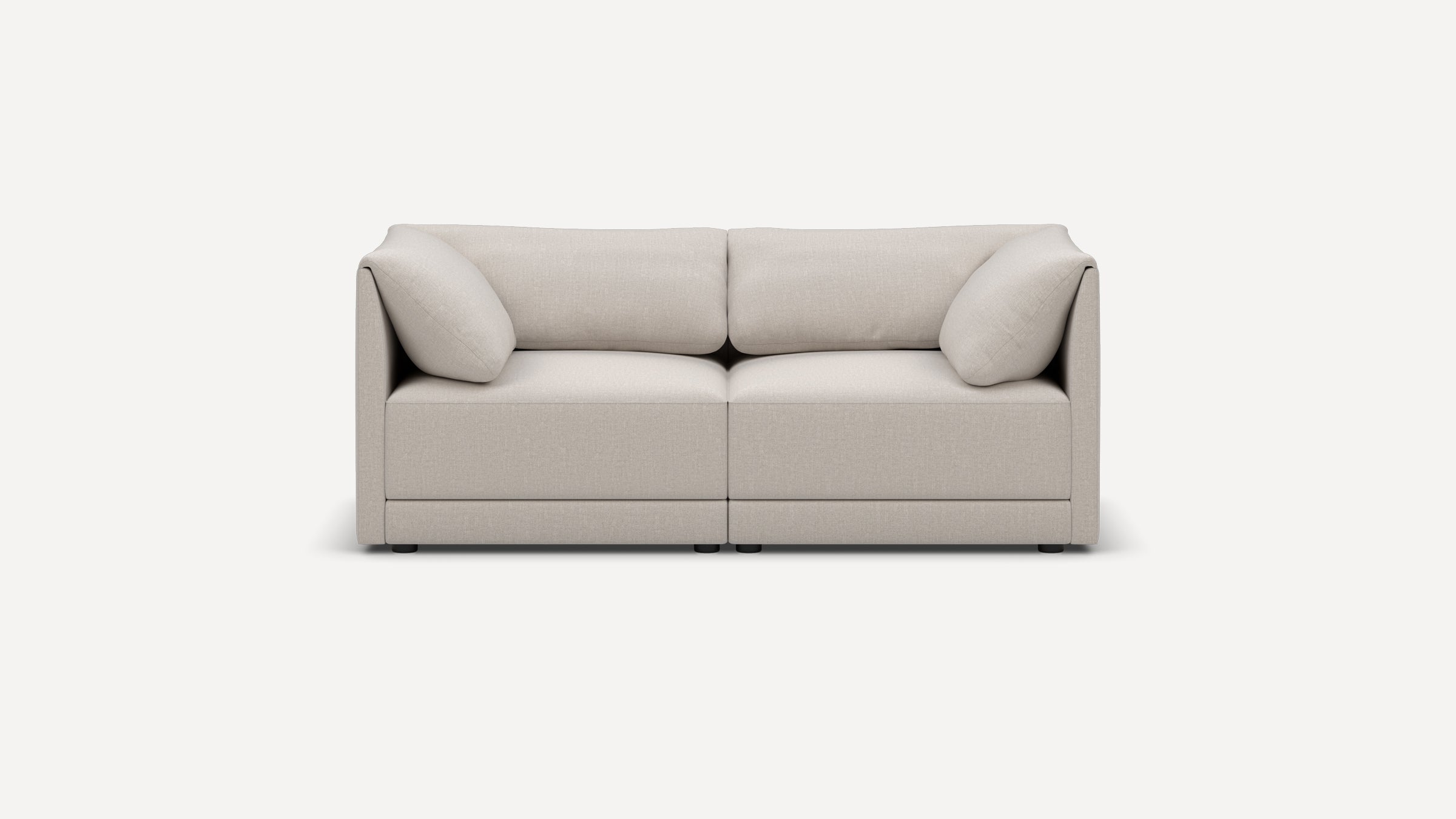 Front view of a modern, beige two-seater sofa with plush cushions and low, boxy armrests on a white background.
