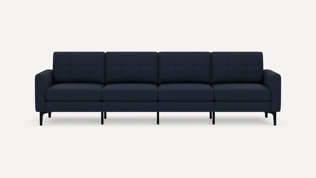 Four-seater modern navy blue fabric sofa with tufted back cushions, straight arms, and black tapered legs on white background.