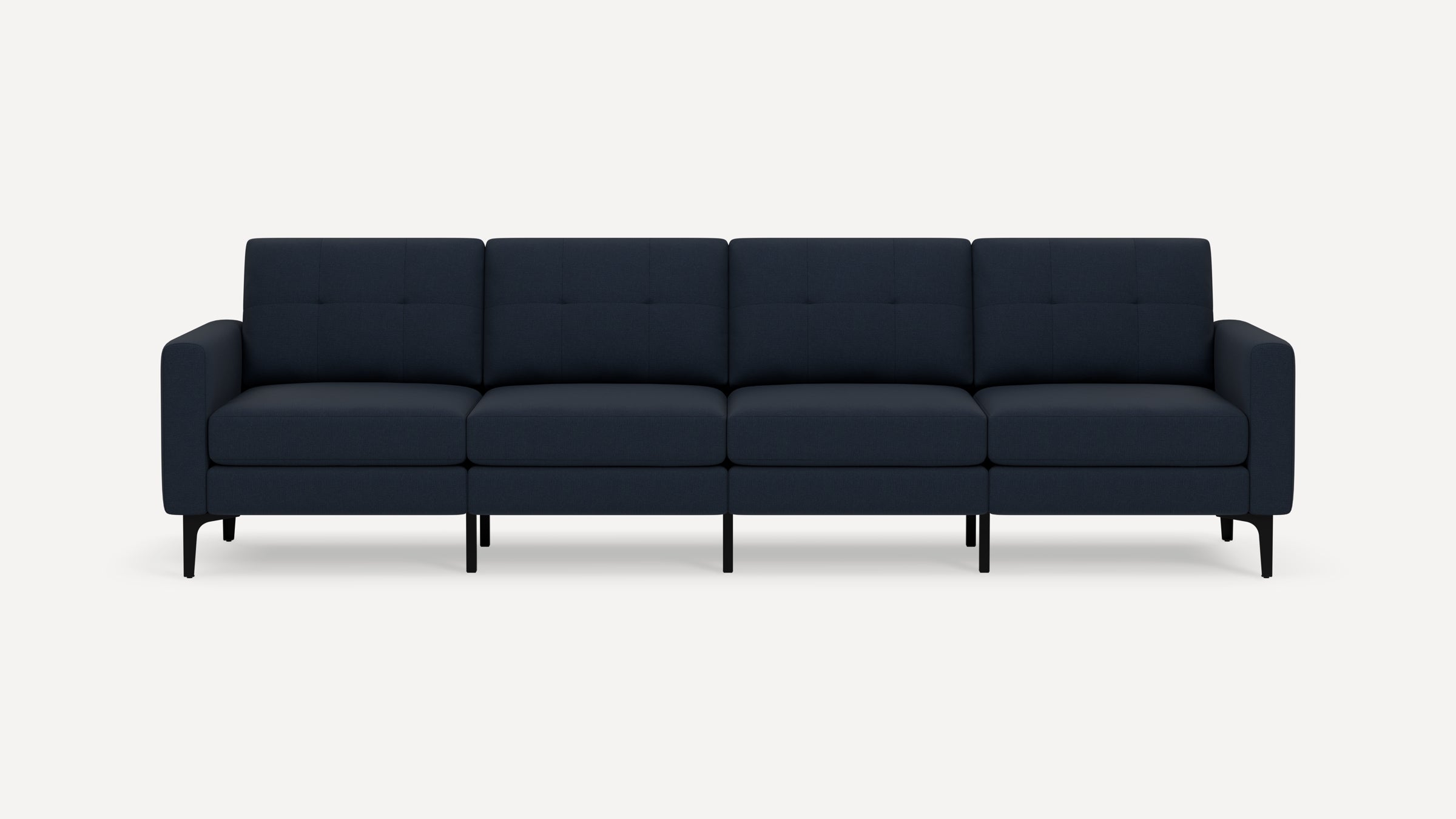 Four-seater modern navy blue fabric sofa with tufted back cushions, straight arms, and black tapered legs on white background.
