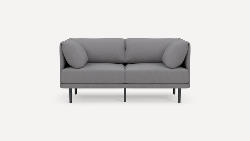 Modern gray two-seater sofa with clean lines, two cylindrical armrest cushions, and slim black metal legs.