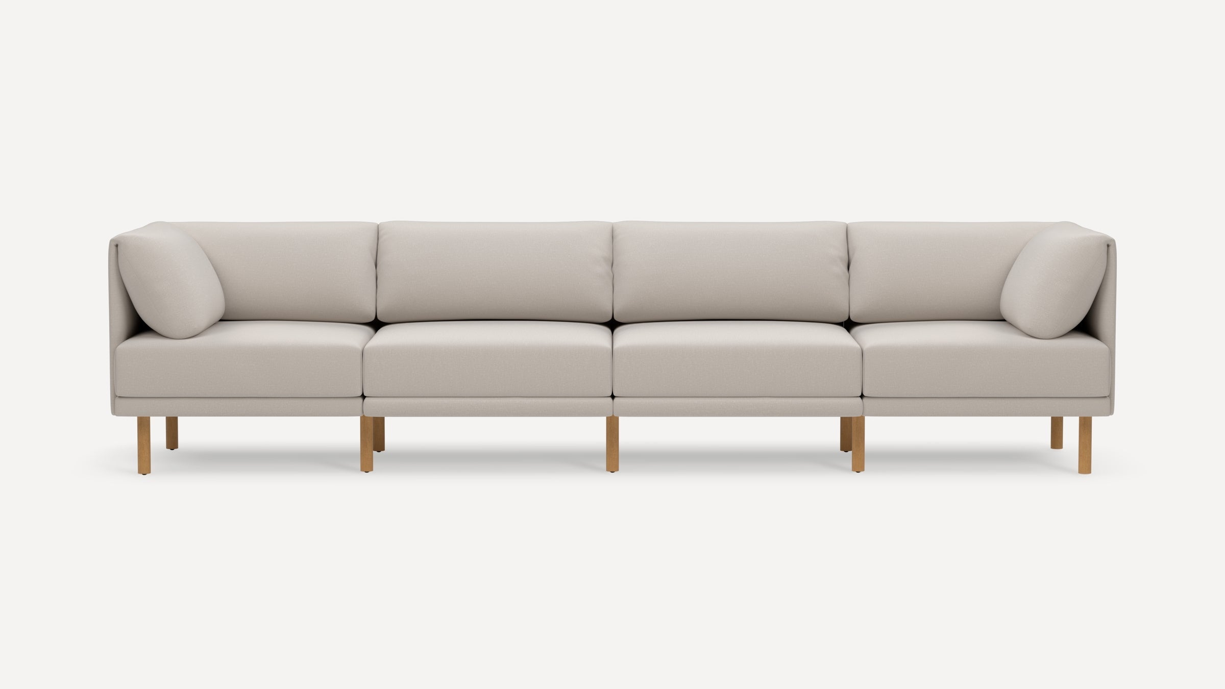 Modern light beige four-seater sofa with wooden legs, featuring square cushions and a minimalist, clean design.