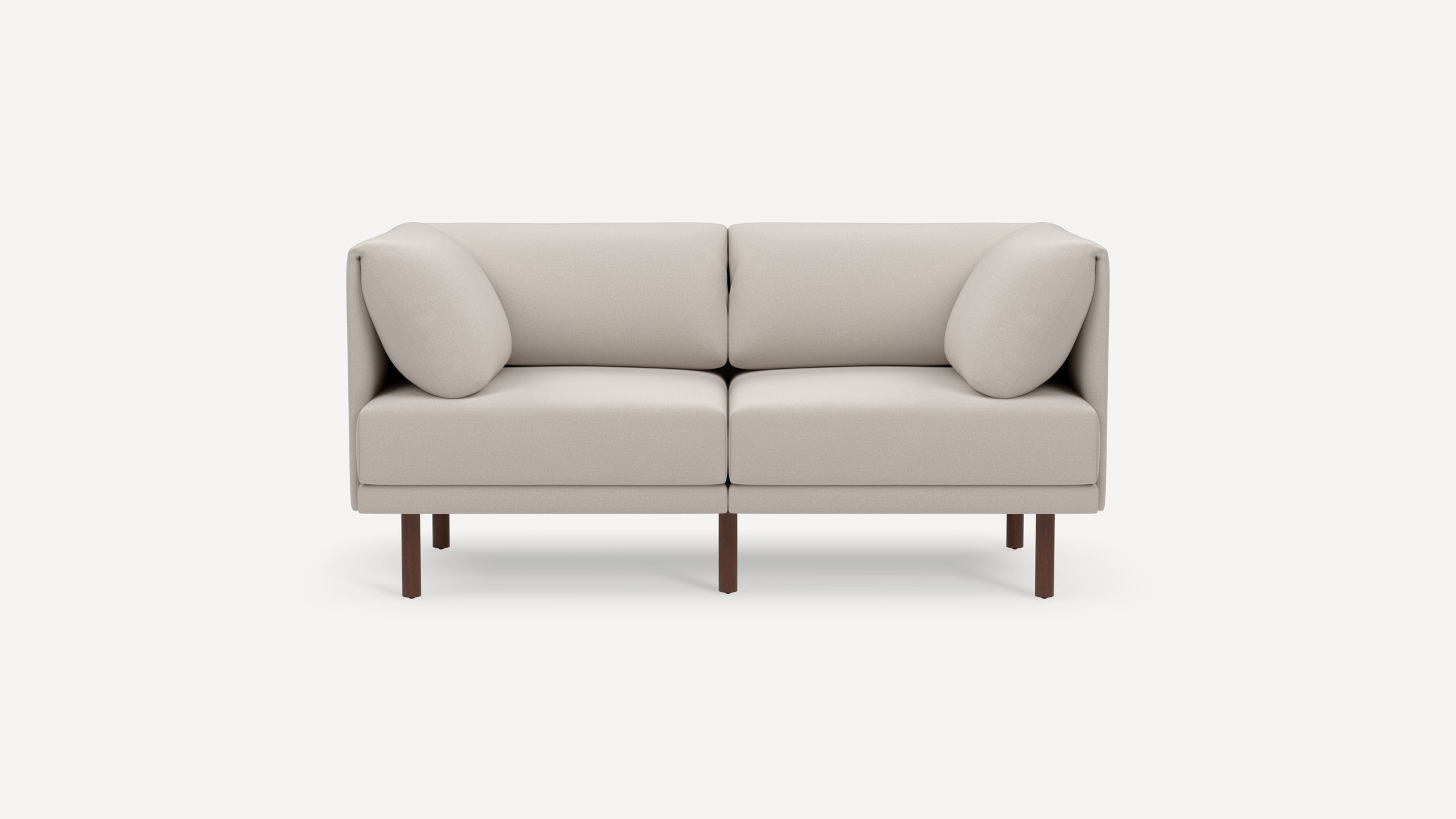 Modern beige two-seater sofa with cushioned armrests and dark wooden legs on a plain white background.