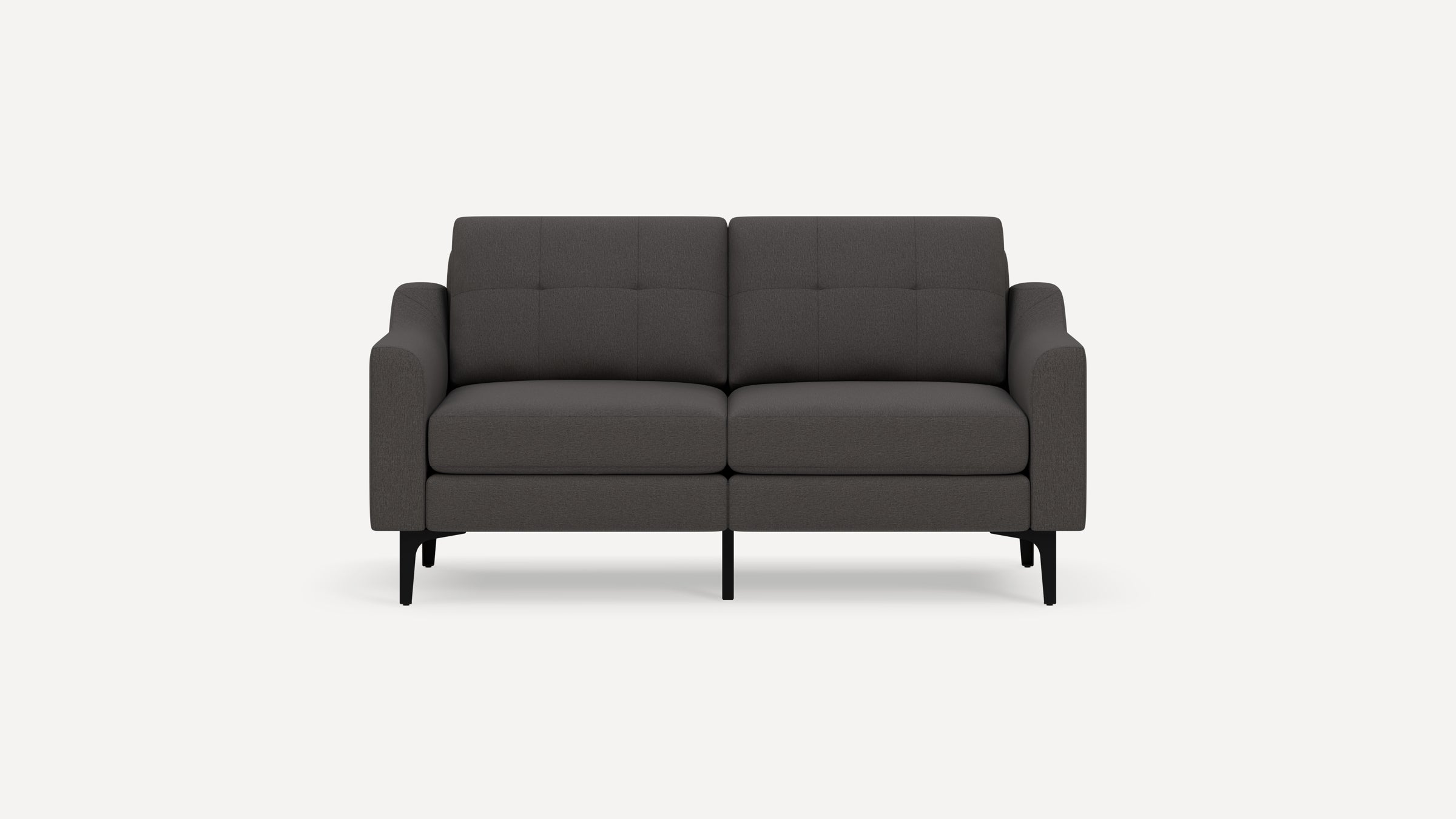 Dark gray modern two-seater sofa with tufted backrest, cushioned armrests, and black angled legs on a plain background.